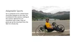 Adaptable Sports Ian is centered on his 3 wheel hand-cycle bike stopped on the road. He is centered